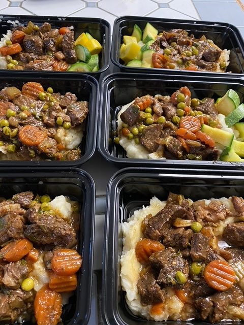 Slow-simmered beef stew with peas and vegitables over homemade mashed potatos